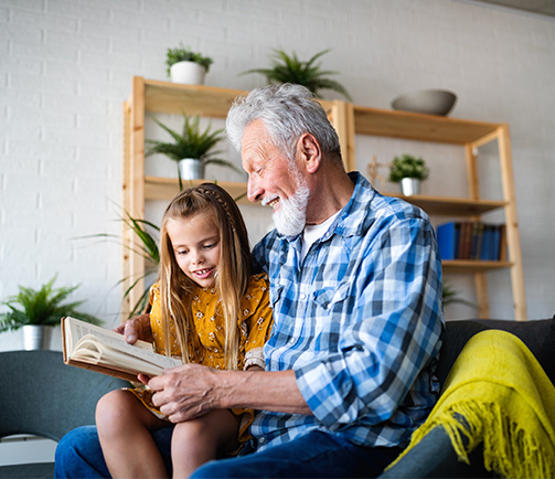 Grandfather Reading Book with Granddaughter Tax Free Retirement California